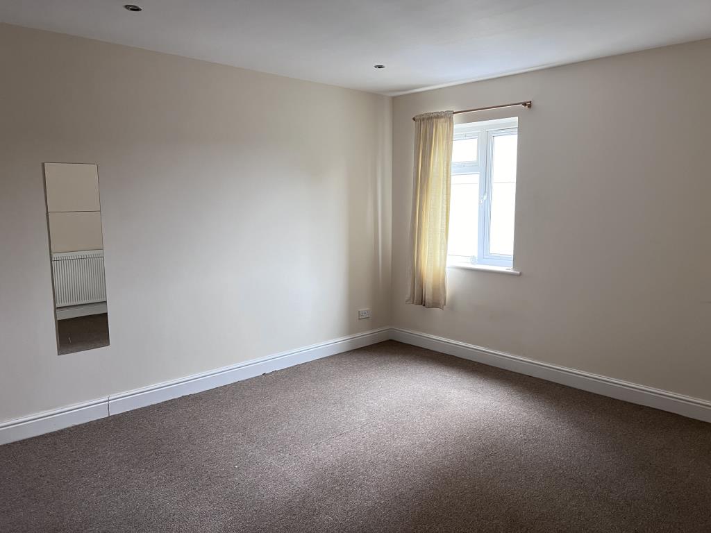 Lot: 139 - THREE-BEDROOM GROUND FLOOR MAISONETTE FOR INVESTMENT OR OCCUPATION - Bedroom two with smooth painted walls and neutral carpet